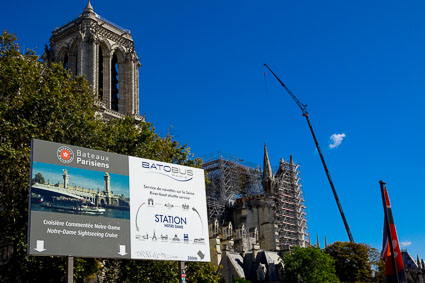 Bateaux Parisiens and Batobos sSign on the Seine by Notre Dame Cathedral