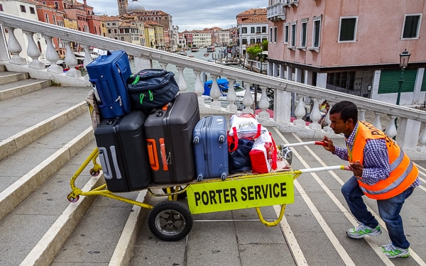 Baggage porter on bridge in Venice