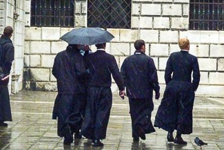 Priests with umbrellas in Venice